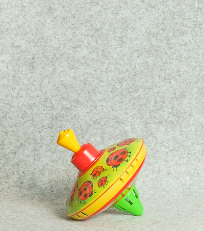 "Trottola Vintage a Carica con le Coccinelle" in plastica e metallo