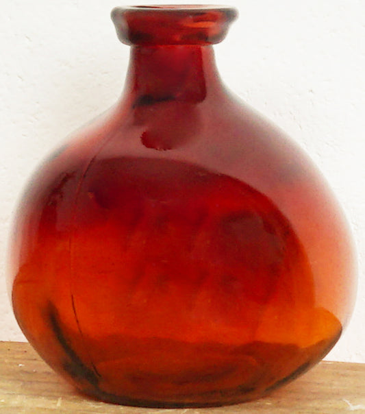 Ampolla in vetro colorato rosso e deformato