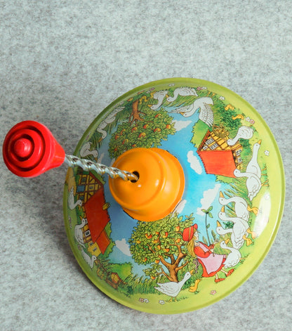 "Trottola Vintage a Carica con le Paperelle" in plastica e metallo