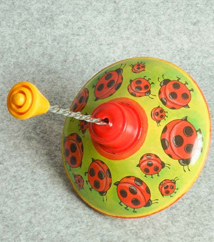 "Trottola Vintage a Carica con le Coccinelle" in plastica e metallo
